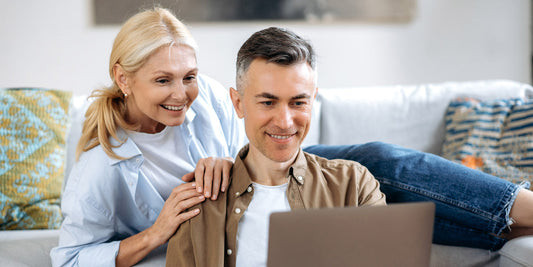Middle aged couple staring at a laptop together