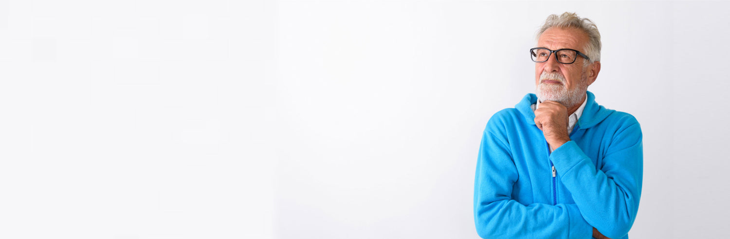 Man wearing a bright turquoise sweatshirt holding his hand under his chin thinking about something