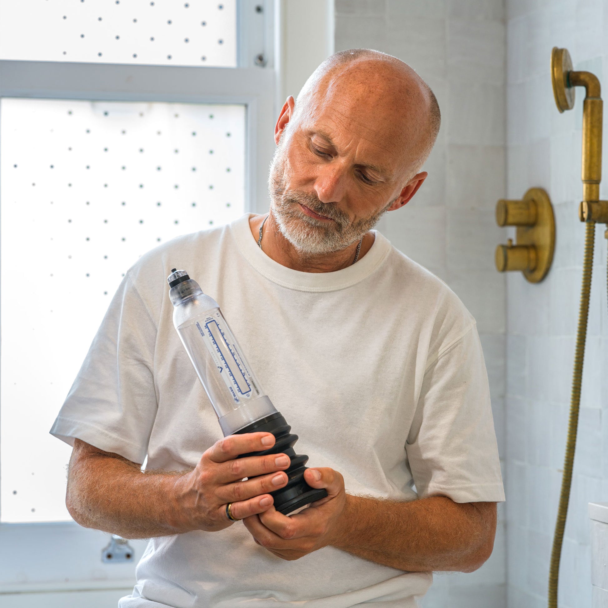 Man holding a VaxAid Trainer Penis Pump