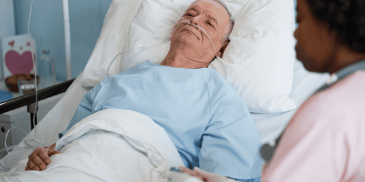 A man recovering in a hospital bed after a prostatectomy, attended by a nurse providing care and support.