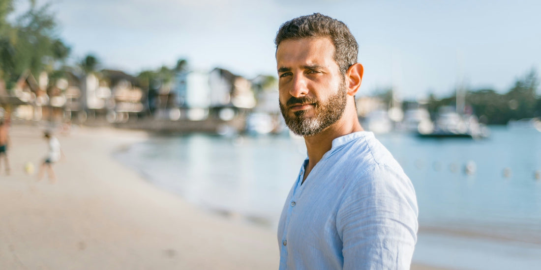 Man standing on beach looking into camera