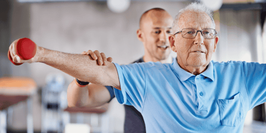 An older man exercises alongside a younger man, highlighting intergenerational fitness and encouragement.