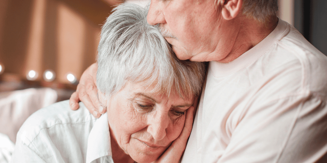 An older couple sharing a warm embrace, expressing love and affection for one another.