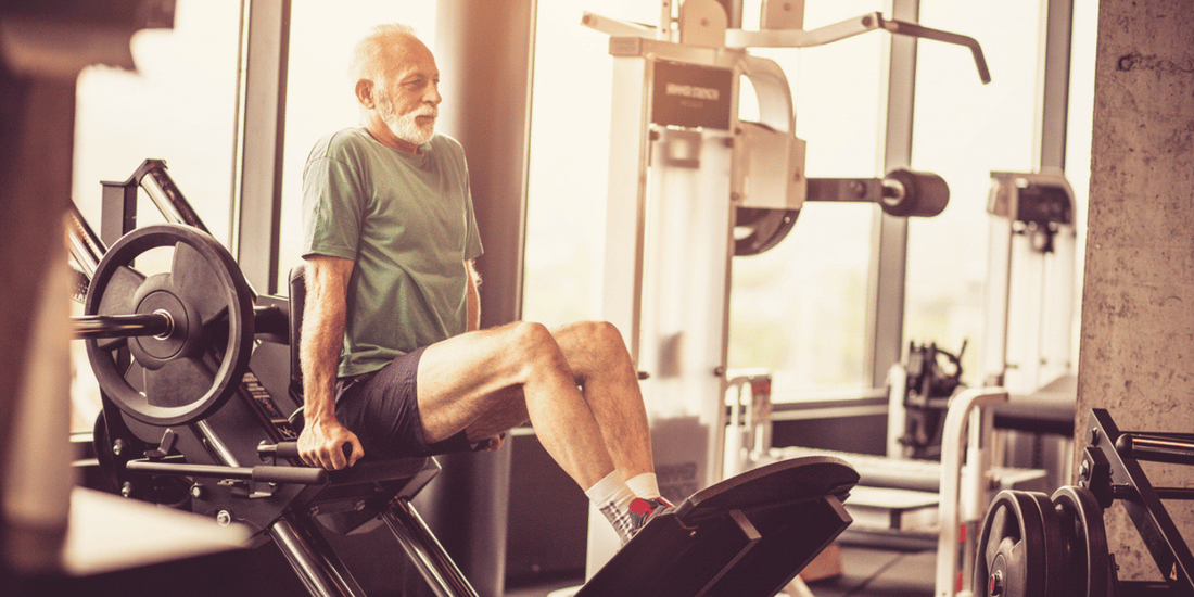 An elderly man working out in a gym, demonstrating commitment to physical fitness.