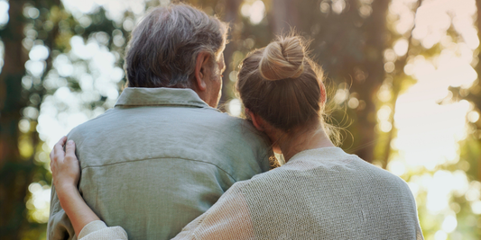 Older couple embracing outdoors, representing support and intimacy when discussing erectile dysfunction after 50.