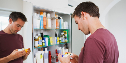 Man looking at medication at home while considering erectile dysfunction treatment options.