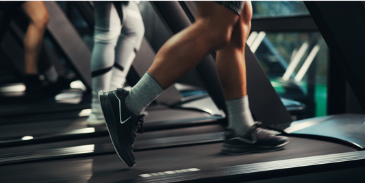 Man running on a treadmill as part of a cardio exercise routine for erectile dysfunction.