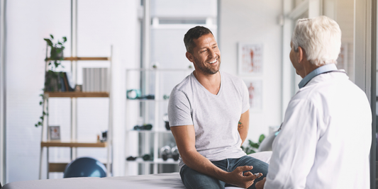 Man discussing erectile dysfunction treatment and vacuum erection device options with a healthcare professional.