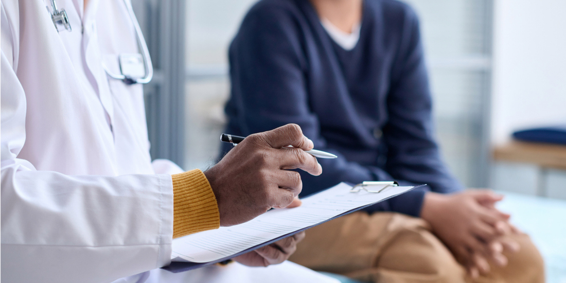 Man speaking with a healthcare professional about recurring erectile dysfunction symptoms and treatment options.