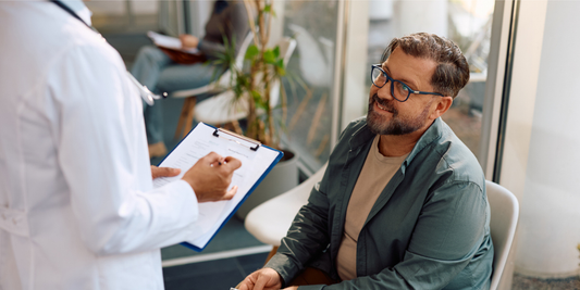 Middle-aged man discussing erectile dysfunction treatment options with a healthcare professional, illustrating guidance on medical vacuum erection devices and penis pumps.