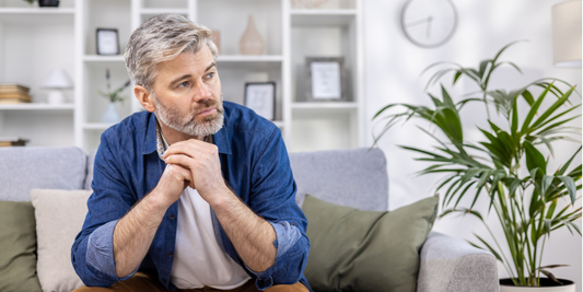 Thoughtful middle-aged man sitting at home, illustrating concerns about changes in low libido, sexual desire and erectile dysfunction in men over 50.