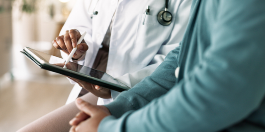 Doctor reviewing treatment information with a patient, illustrating a discussion about erectile dysfunction after prostate radiotherapy or surgery.