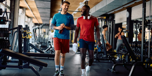 Two men walking and talking in a gym after exercise, representing physical activity and recovery after prostatectomy.