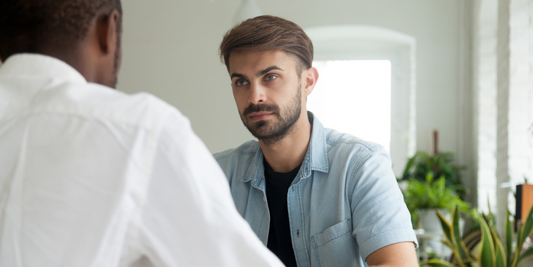 Man having a private conversation with a healthcare professional about erectile dysfunction treatment options and ED devices.