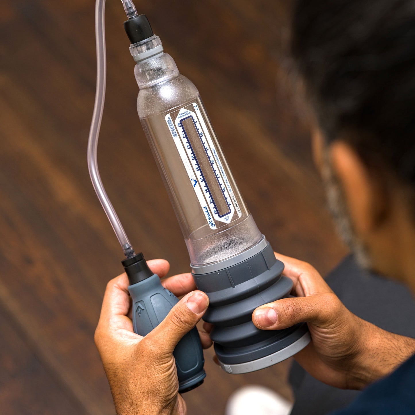 Man holding a VaxAid Deluxe Vacuum Pump