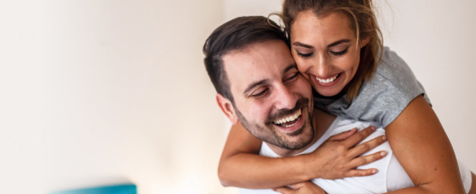 A woman hugging a man from behind
