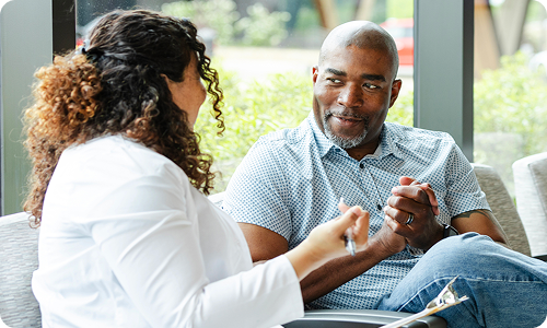 A man sitting with a doctor having a discussion